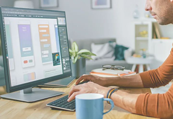 Designer working on digital marketing creative at a desktop computer