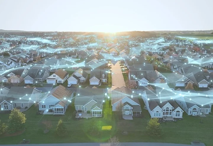 Aerial view of a connected suburban neighborhood with a digital network overlay
